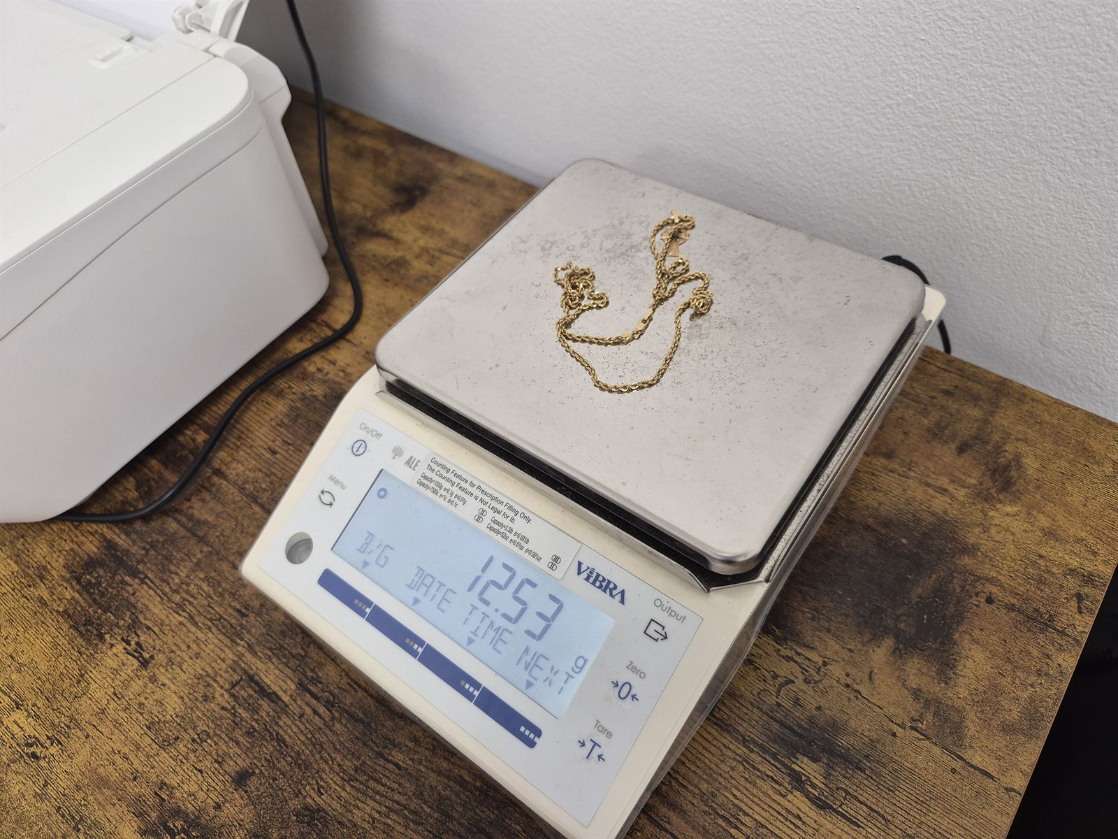 A 14K gold rope chain being weighed on our precision scale during a Charlottesville jewelry buying appointment